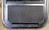 Used Black Radius Opening Window : 17 1/2" W x 21 1/2" H x 1 3/4" D - Young Farts RV Parts