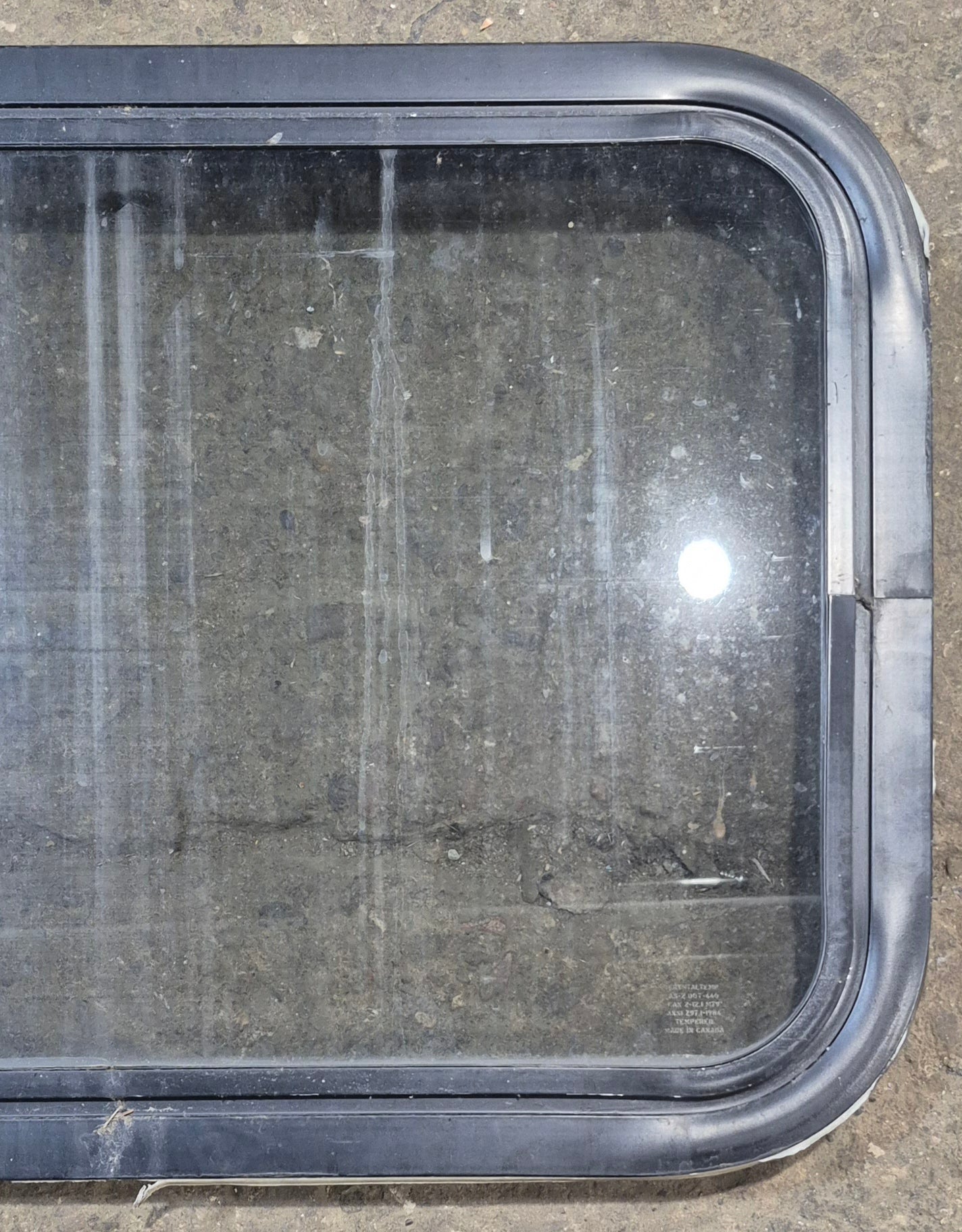 Used Black Radius Non Opening Window : 24 1/4" W x 16 3/4" H x 1 7/8" - Young Farts RV Parts