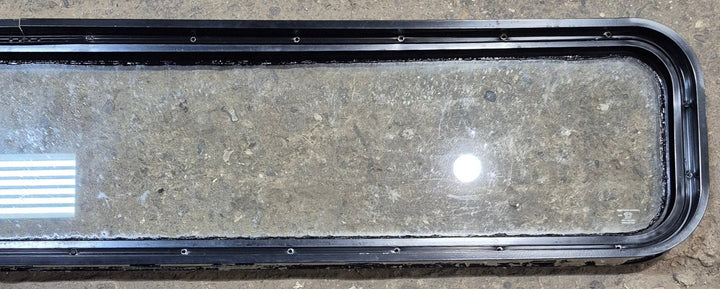 Used Black Radius Non Opening Window : 72 1/4" W x 11 3/4" H x 1 7/8" - Young Farts RV Parts