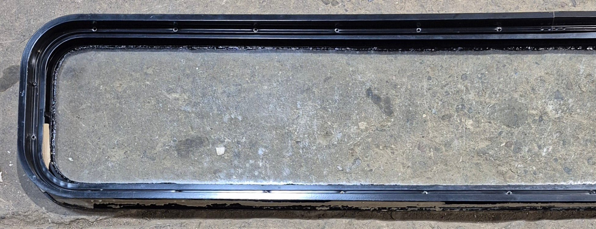 Used Black Radius Non Opening Window : 72 1/4" W x 11 3/4" H x 1 7/8" - Young Farts RV Parts