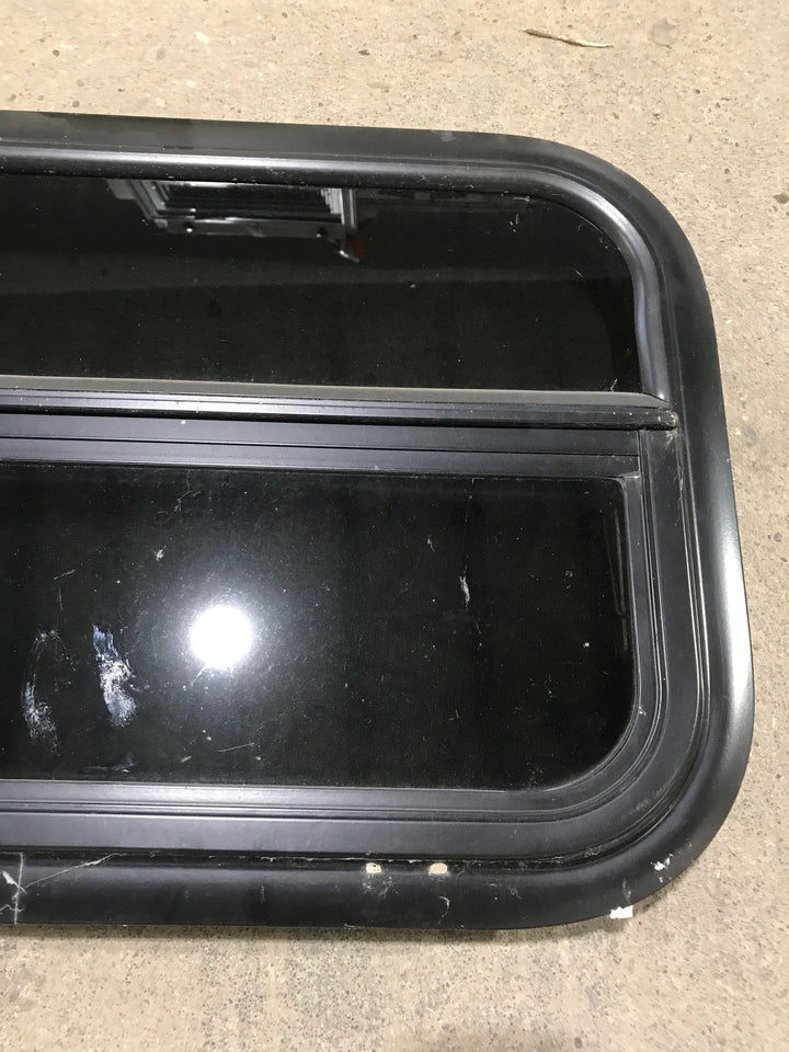 Used Black Radius Opening Window : 23 1/2" W x 14 1/2" H x 1 7/8" - Young Farts RV Parts