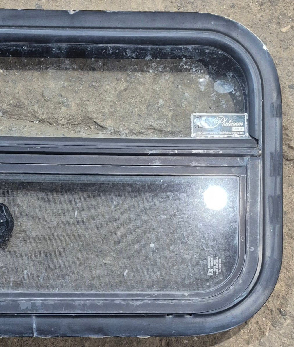 Used Black Radius Opening Window : 23 1/4" W x 14 1/4" H x 1 7/8" - Young Farts RV Parts