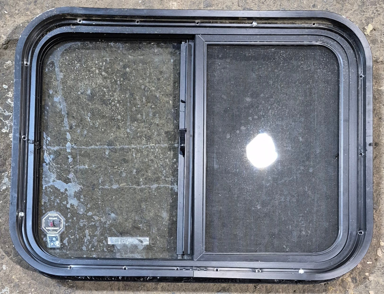 Used Black Radius Opening Window : 23 3/4" W x 17 3/4" H x 1 7/8" - Young Farts RV Parts