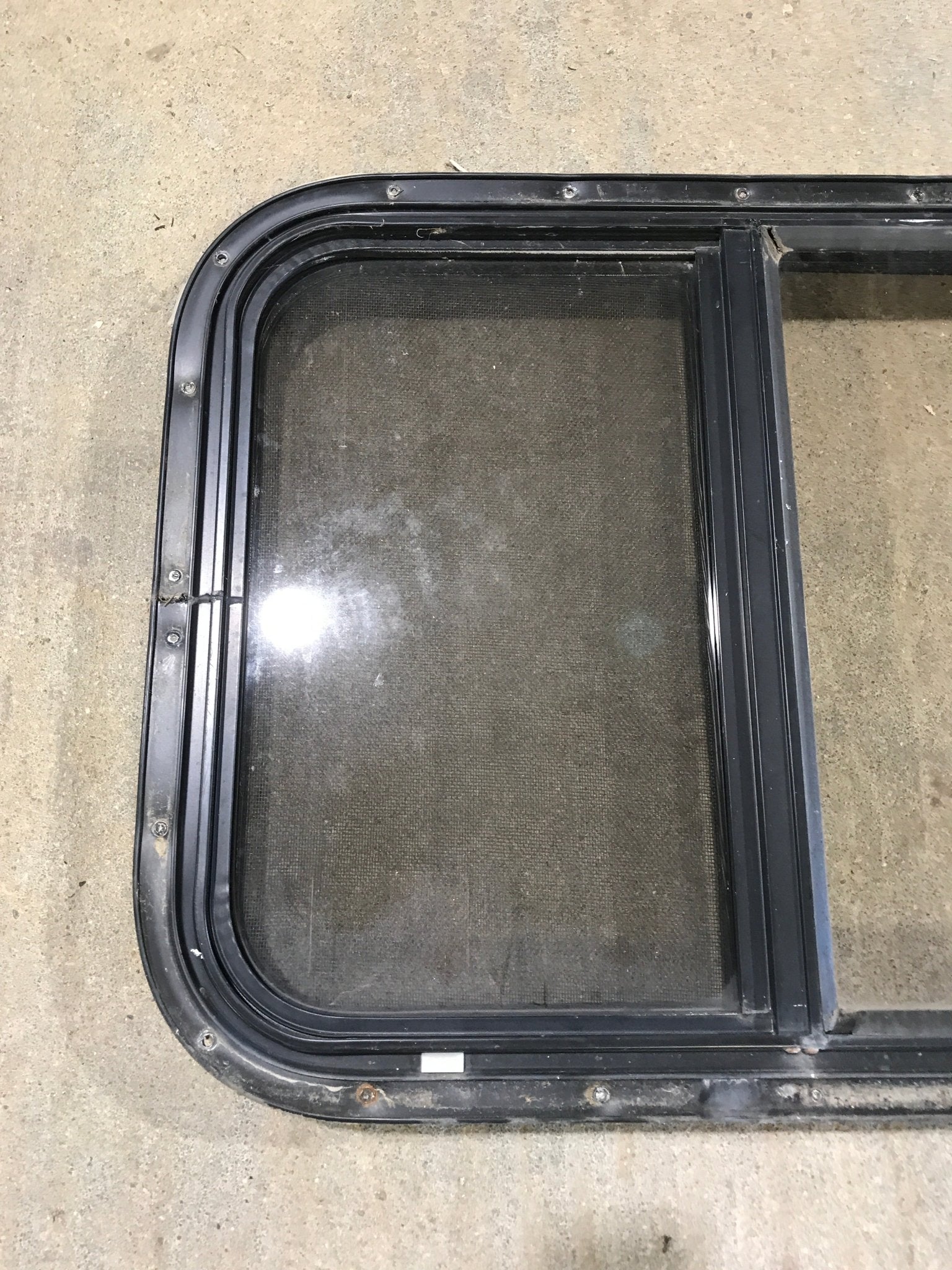 Used Black Radius Opening Window : 24 1/2" W x 19 1/4" H x 1 1/4" - Young Farts RV Parts