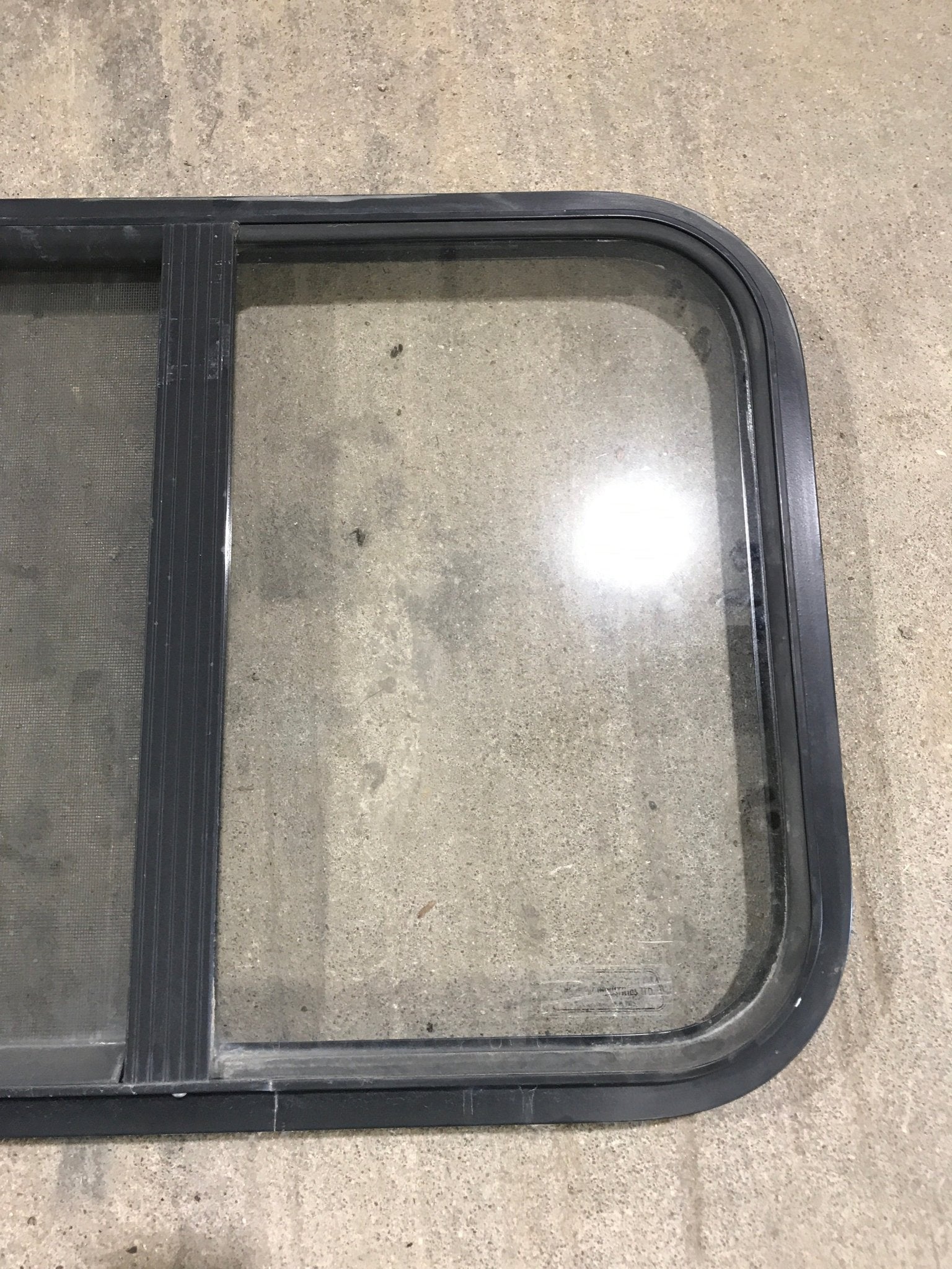 Used Black Radius Opening Window : 24 1/4" W x 17 3/4" H x 1 1/4" - Young Farts RV Parts