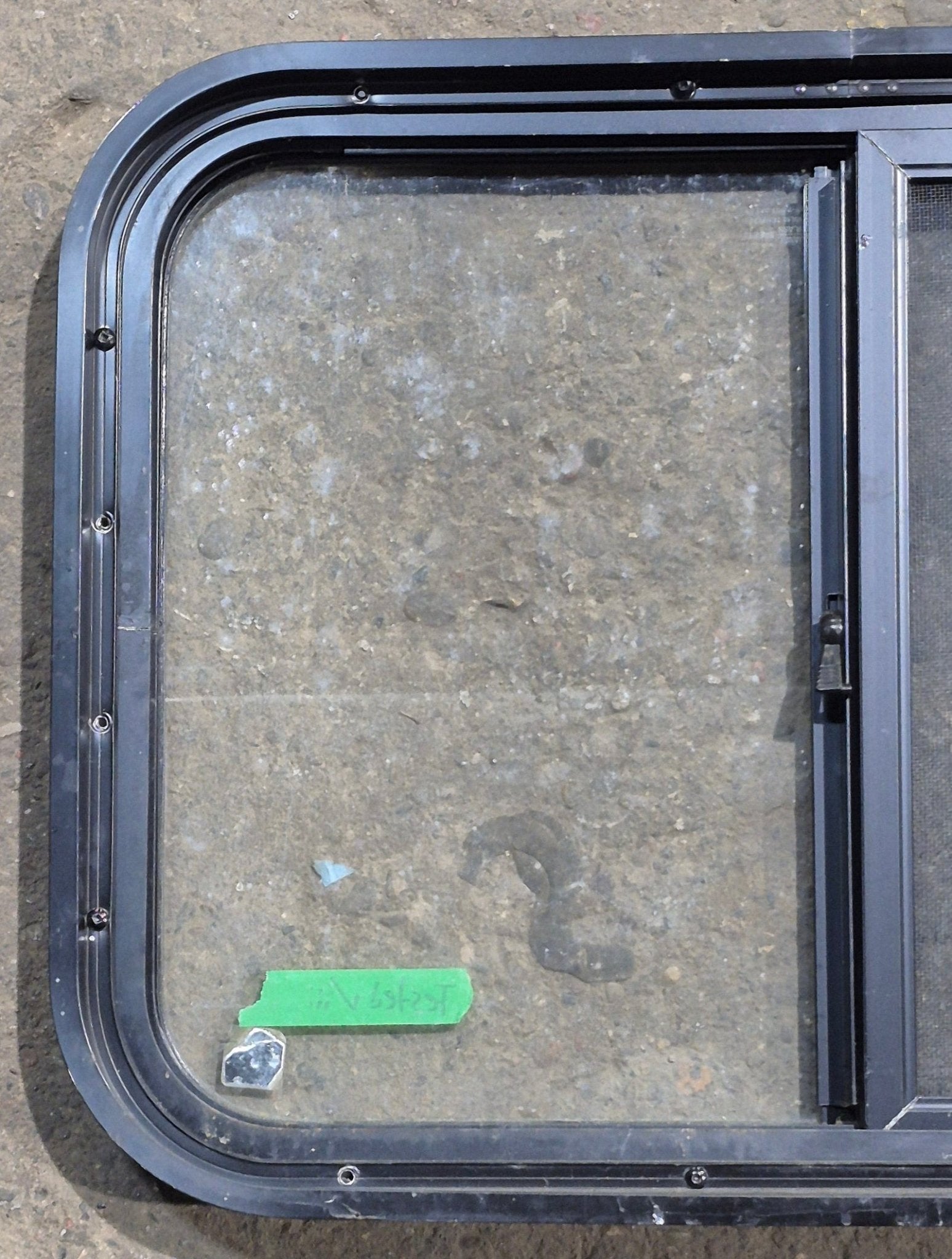 Used Black Radius Opening Window : 24 1/4" W x 17 3/4" H x 1 5/8" D - Young Farts RV Parts