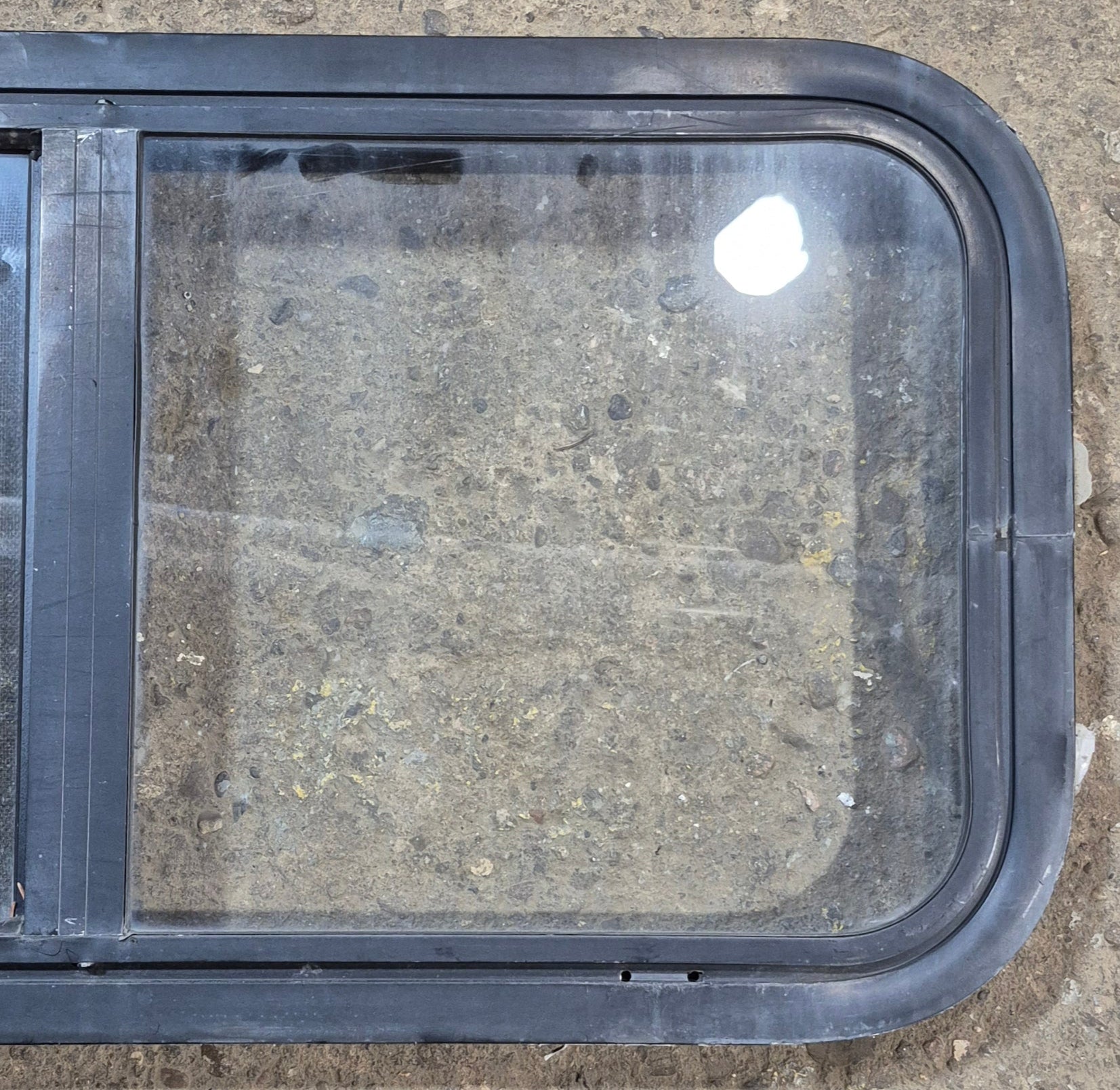 Used Black Radius Opening Window : 29 1/2" W x 14 3/4" H x 1 7/8" - Young Farts RV Parts