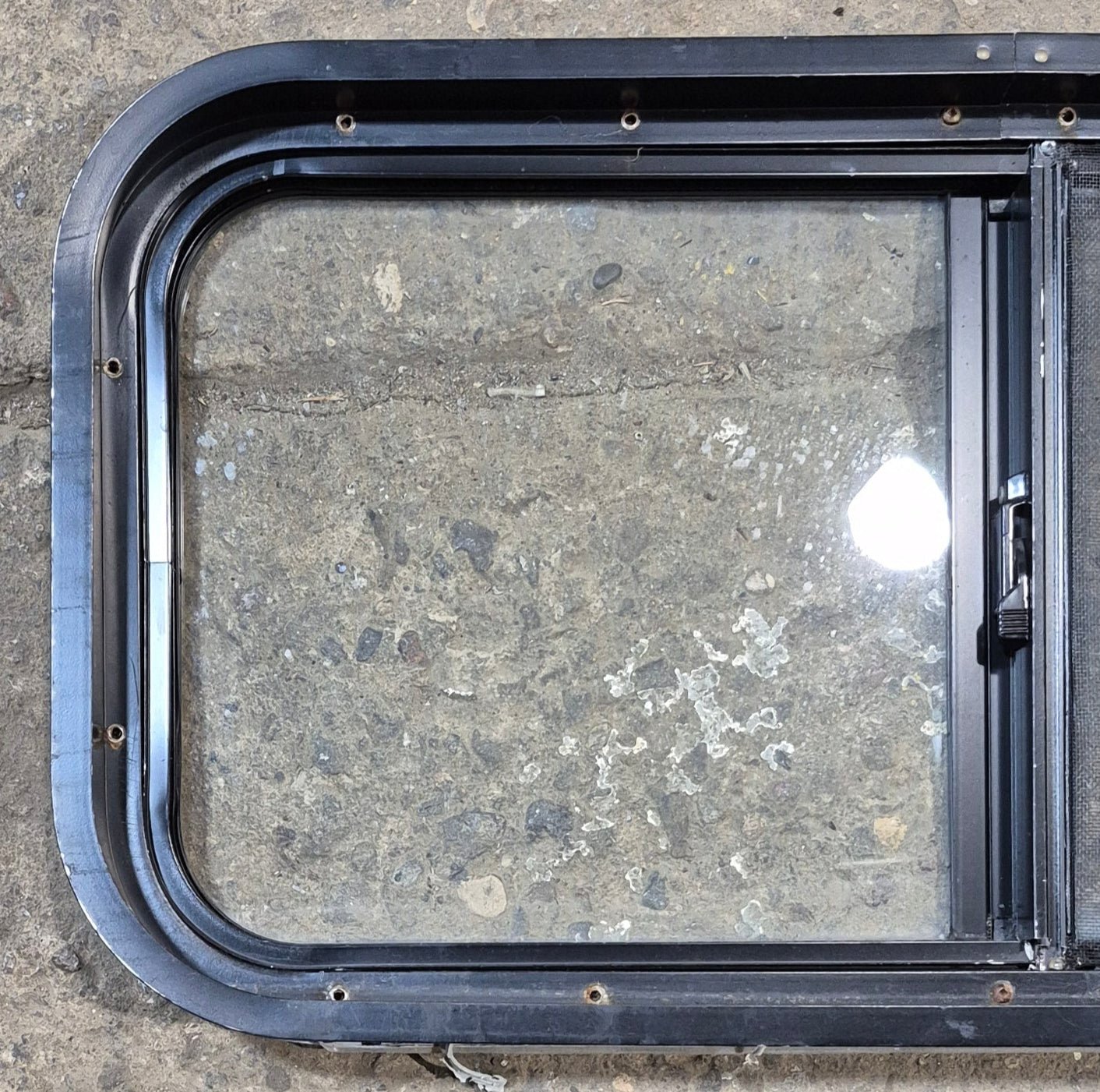 Used Black Radius Opening Window : 29 1/2" W x 14 3/4" H x 1 7/8" - Young Farts RV Parts