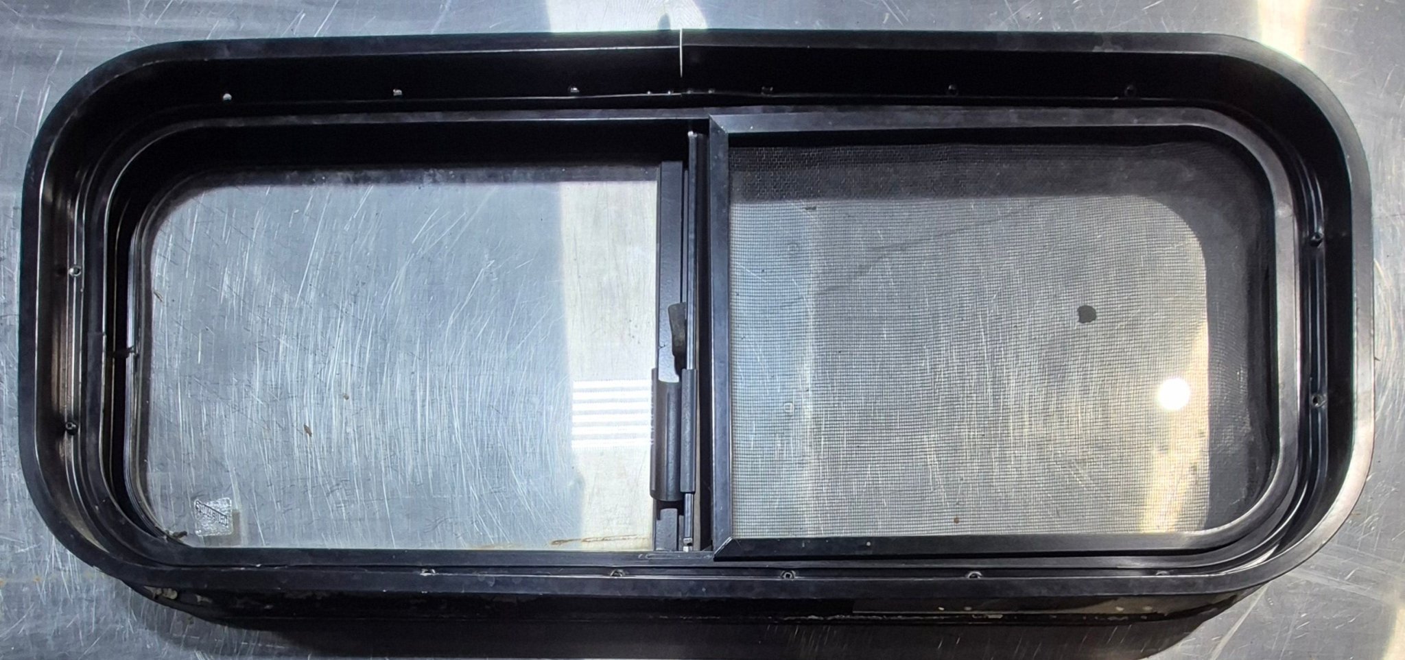 Used Black Radius Opening Window : 30 1/4" W x 11 3/4" H x 1 3/4" - Young Farts RV Parts