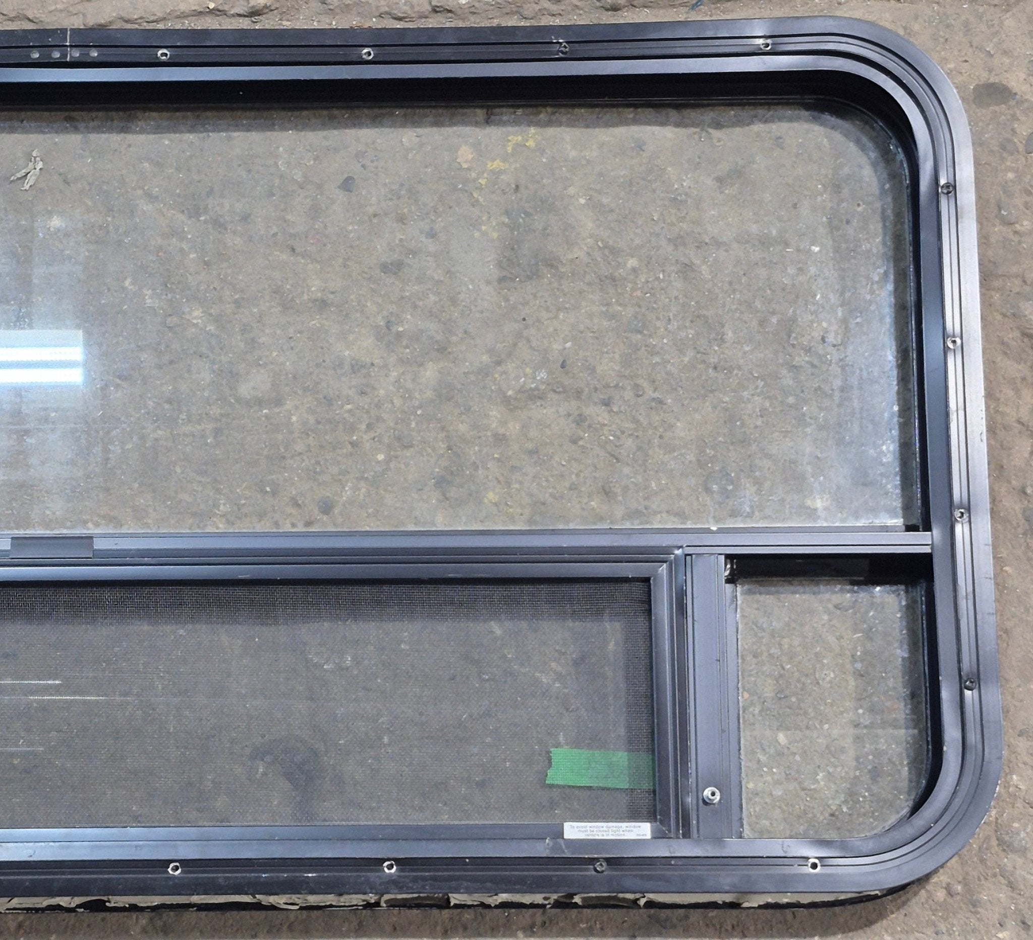 Used Black Radius Opening Window : 45 1/4" W x 21 1/4" H x 1 7/8" D - Young Farts RV Parts