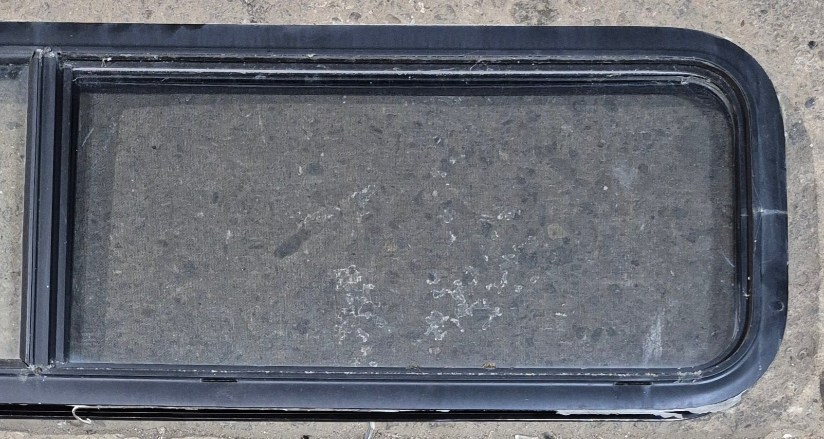 Used Black Radius Opening Window : 59 1/4" W x 14 1/4" H x 1 3/4" - Young Farts RV Parts