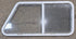 Used Slanted White Radius Opening Window : 46 3/4" W x 21 1/4" H x 1 1/4" D - Young Farts RV Parts