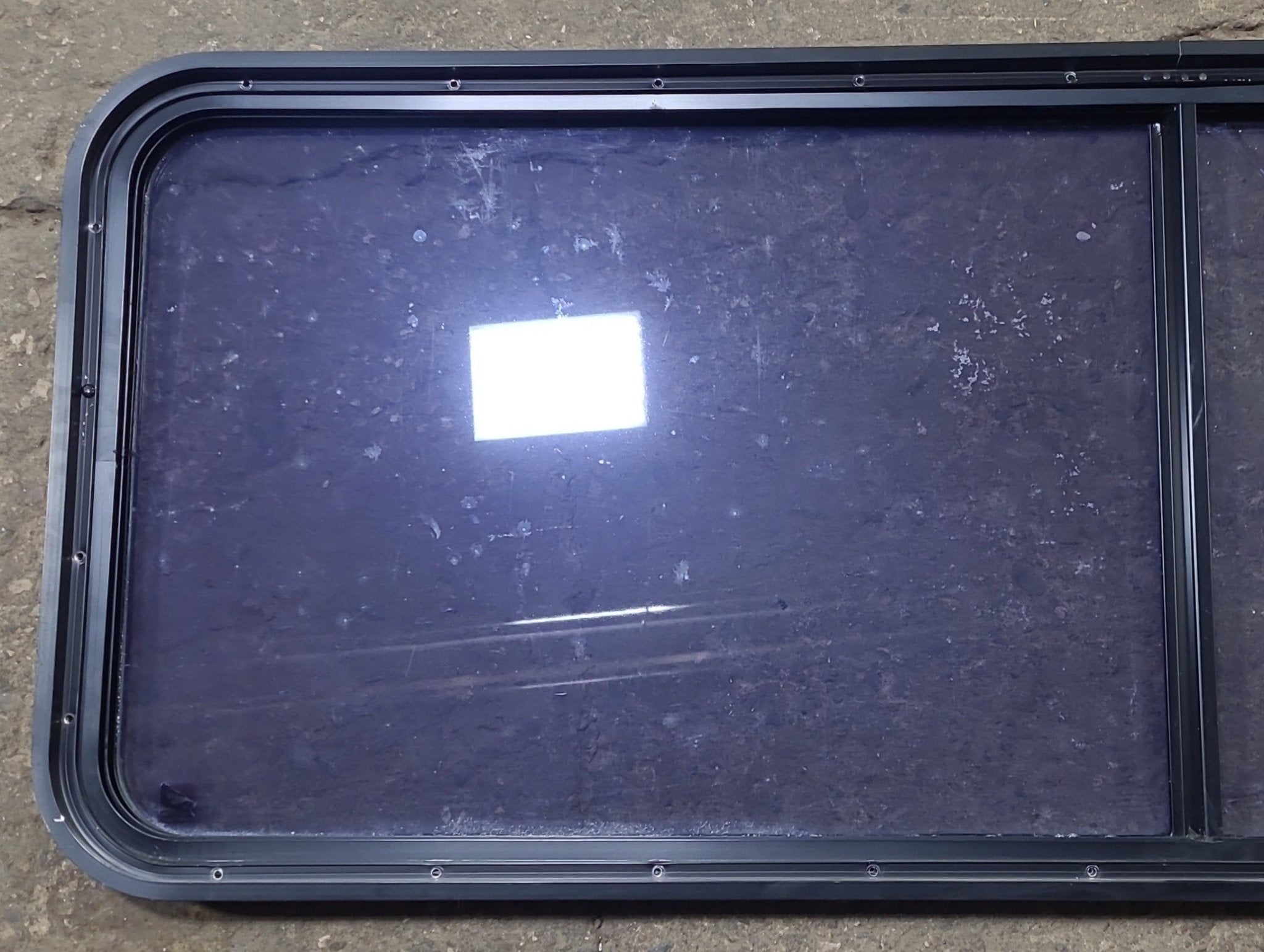 Used Black Radius Non Opening Window : 60 1/2" W x 21 3/4" H x 1 3/4" D - Young Farts RV Parts