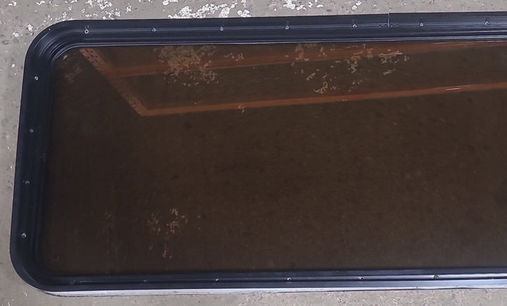 Used Black Radius Non Opening Window : 60 1/2" W x 21 3/4" H x 1 7/8" D - Young Farts RV Parts