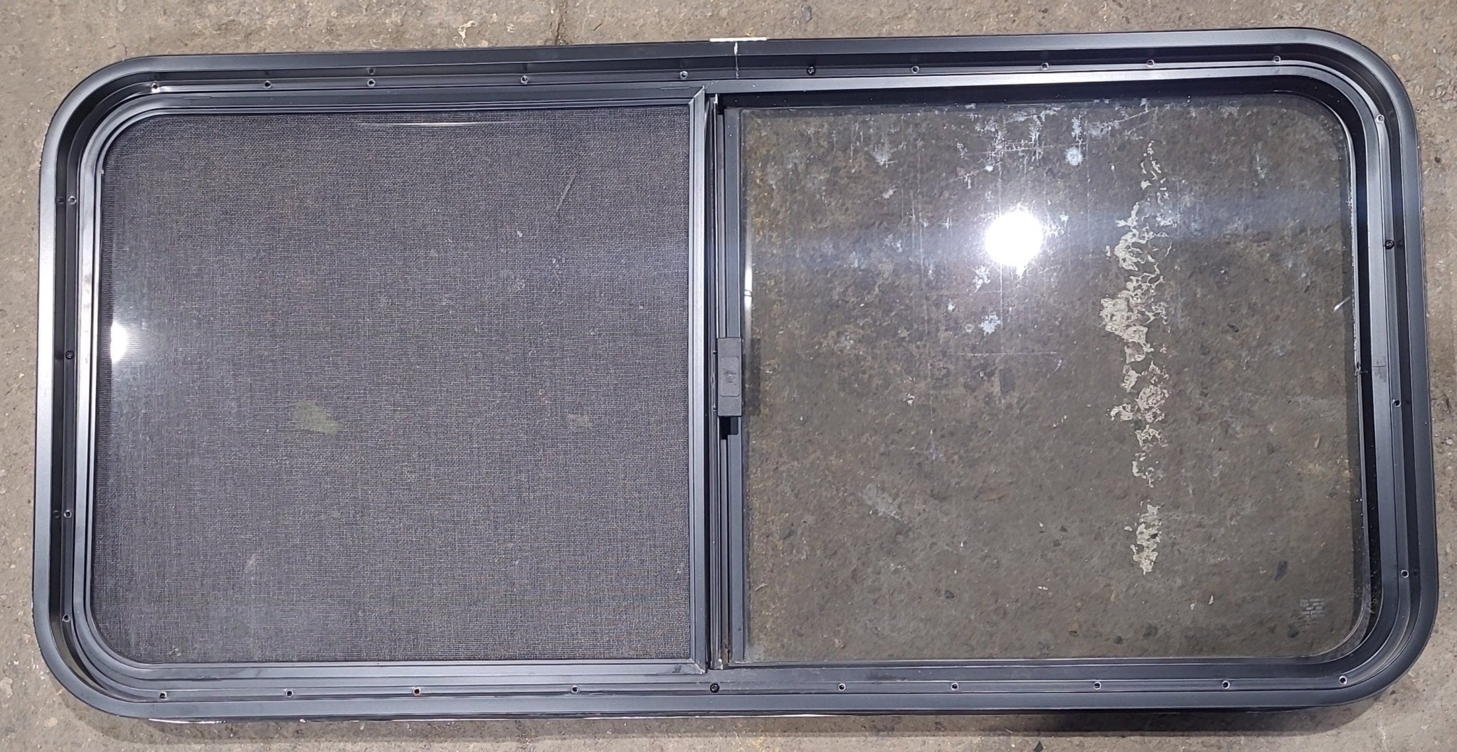 Used Black Radius Opening Window : 45 1/2" W x 21 1/2" H x 1 3/4" D - Young Farts RV Parts