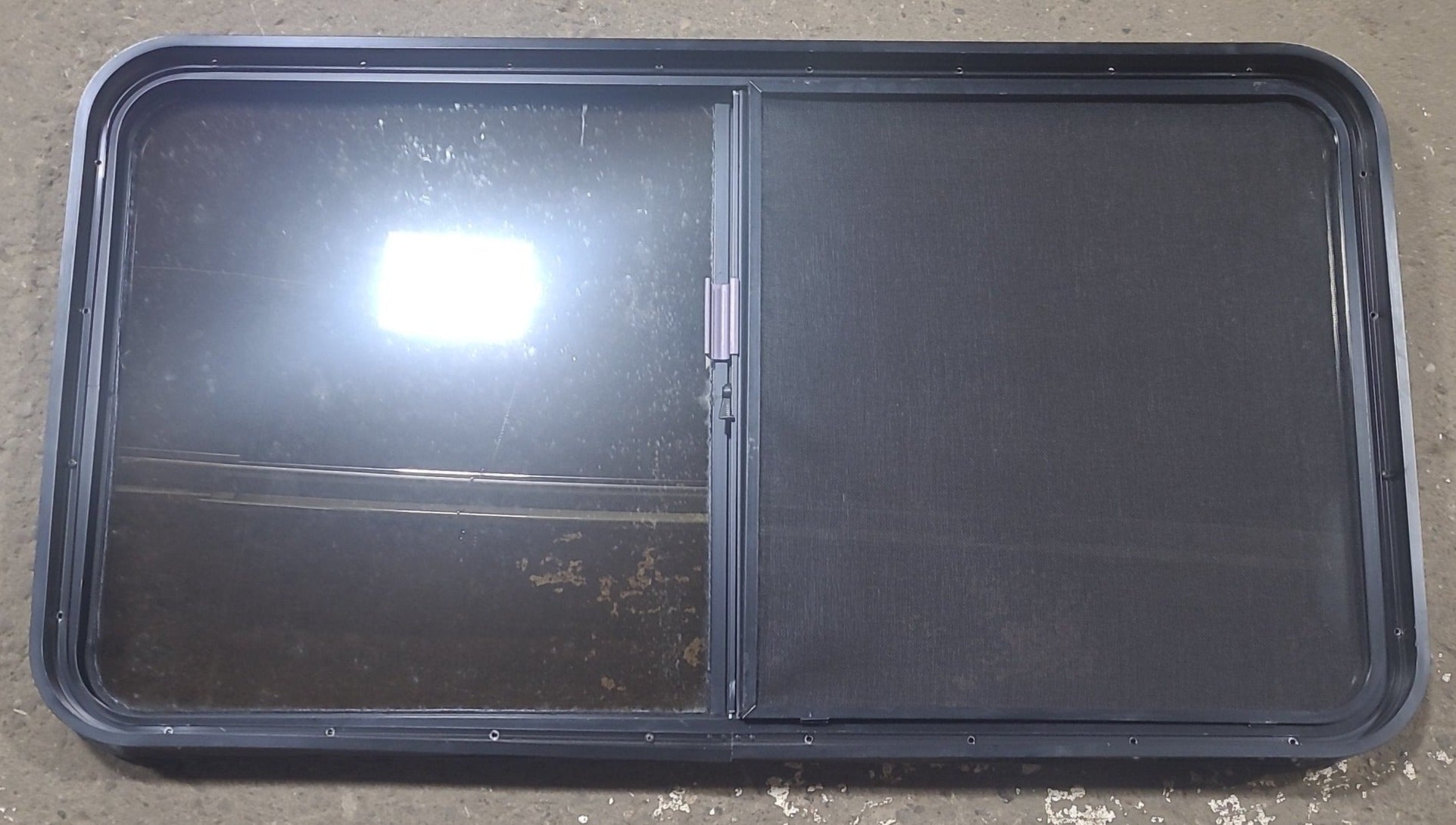 Used Black Radius Opening Window : 48 1/2" W x 261/4" H x 1 3/4" D - Young Farts RV Parts