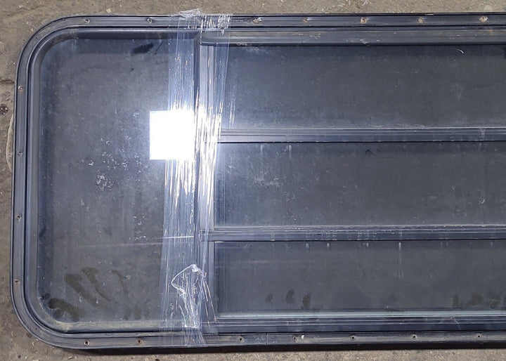 Used Black Radius Opening Window : 60 3/4" W x 23" H x 1 3/8" D - Young Farts RV Parts